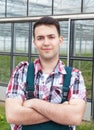 Farmer with crossed arms in front of his greenhouse Royalty Free Stock Photo