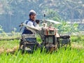 A FARMER cultivating a field with a modern plow before the planting season arrives in the rice fields around Rawa Pening