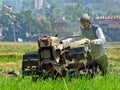 A FARMER cultivating a field with a modern plow before the planting season arrives in the rice fields around Rawa Pening