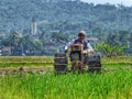 A FARMER cultivating a field with a modern plow before the planting season arrives in the rice fields around Rawa Pening