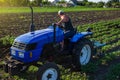 A farmer is cultivating a potato plantation. Young potatoes bushes Agroindustry and agribusiness. Farm machinery. Crop care, soil Royalty Free Stock Photo