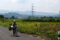 a farmer is cycling for activities on a sunny morning with a beautiful natural scenery background