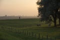 A farmer cycling during sunset Royalty Free Stock Photo