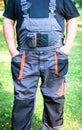 Farmer in dark work overalls with braces