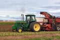 Farmer in tractor digging sugarbeets during harvest in Colorado