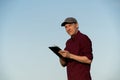 Farmer with digital tablet on a rye field. Smart farming and digital transformation in agriculture..