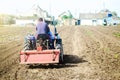 The farmer drives a tractor with a milling unit equipment. Loosening surface, land cultivation Use of agricultural machinery