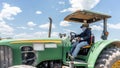 Farmer driving a green tractor under the blue sky