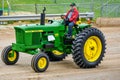 Farmer Driving John Deere Tractor in Antique Parade