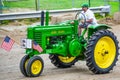 Farmer Driving John Deere Tractor in Antique Parade