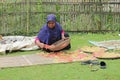 a farmer drying food in the form of crackers to dry in the hot sun