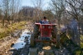 Farmer family driving a tractor on a muddy rural road Royalty Free Stock Photo