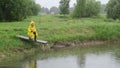 Farmer feed fish rain