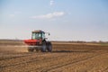 Farmer fertilizing arable land