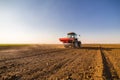 Farmer fertilizing arable land