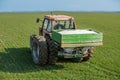 Farmer fertilizing wheat with nitrogen, phosphorus, potassium fertilizer. Royalty Free Stock Photo