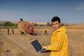 Farmer in field with tractor in background Royalty Free Stock Photo