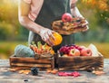 Farmer with fresh fruit on hands. Fall harvest cornucopia. Autumn season and Thanksgiving day concept Royalty Free Stock Photo