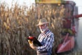 Farmer in front of combine harvester Royalty Free Stock Photo