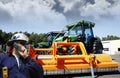 Farmer in front of giant tractor Royalty Free Stock Photo