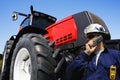 Farmer in front of giant tractor