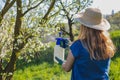 Use spray bottle with insecticide in orchard Royalty Free Stock Photo