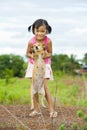 Farmer girl holding a dog