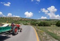 A farmer goes by a tractor on the village road that goes curling. Village life in Turkey. Kizilcahamam, Ankara