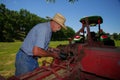 Farmer Greases His Hay Baler Royalty Free Stock Photo