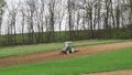 Farm tractor harrowing arable field