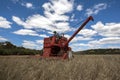 A farmer harvests a broadacre paddock of wheat.