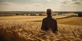 Farmer in a hat standing in the ears of corn his back to camera. Man enjoying the beautiful agricultural landscape. Generative AI Royalty Free Stock Photo