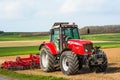 farmer with his tractor equipped with a disc plow to plow the fields