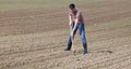 Farmer hoeing soil