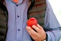 farmer hold red ripe apple in a hand