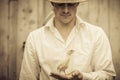 Farmer Holding a Baby Turkey