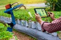 Farmer holding a tablet smart arm robot work agricultural machinery