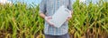 Farmer holding unlabeled pesticide jug in field Royalty Free Stock Photo