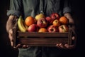 The farmer is holding a wooden box full of fresh fruits. Fruit basket apples, bananas, oranges. ai generative Royalty Free Stock Photo