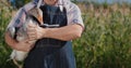 A farmer holds a large goose. Poultry and food from local farmers