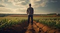 A farmer inspects his field, rear view Royalty Free Stock Photo