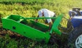 The farmer inspects and repair adjustment of agricultural equipment for digging out potatoes. Harvesting potatoes in autumn.