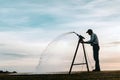 Silhouette of Farmer Irrigating Royalty Free Stock Photo