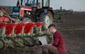 Farmer with laptop and tractors