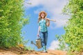 Farmer little girl. garden tools, shovel and watering can. kid worker sunny outdoor. family bonding. spring country side Royalty Free Stock Photo