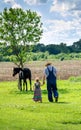 Farmer and little girl walking