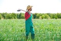 Farmer man with hoe looking at his field Royalty Free Stock Photo