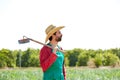 Farmer man with hoe looking at his field Royalty Free Stock Photo