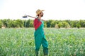 Farmer man with hoe looking at his field Royalty Free Stock Photo