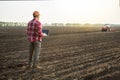Farmer man with laptop standing on farming land Royalty Free Stock Photo